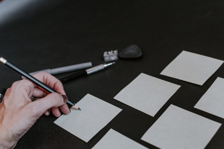 A person is drawing squares on a table