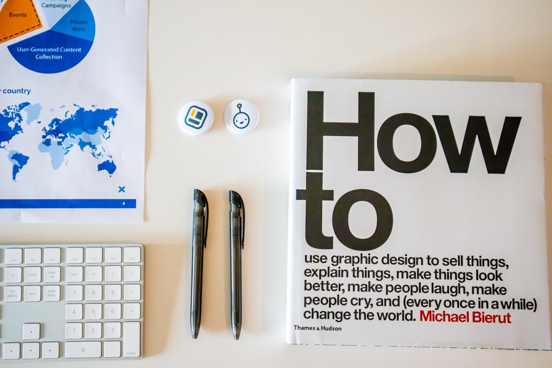 a magazine sitting on top of a desk next to a keyboard